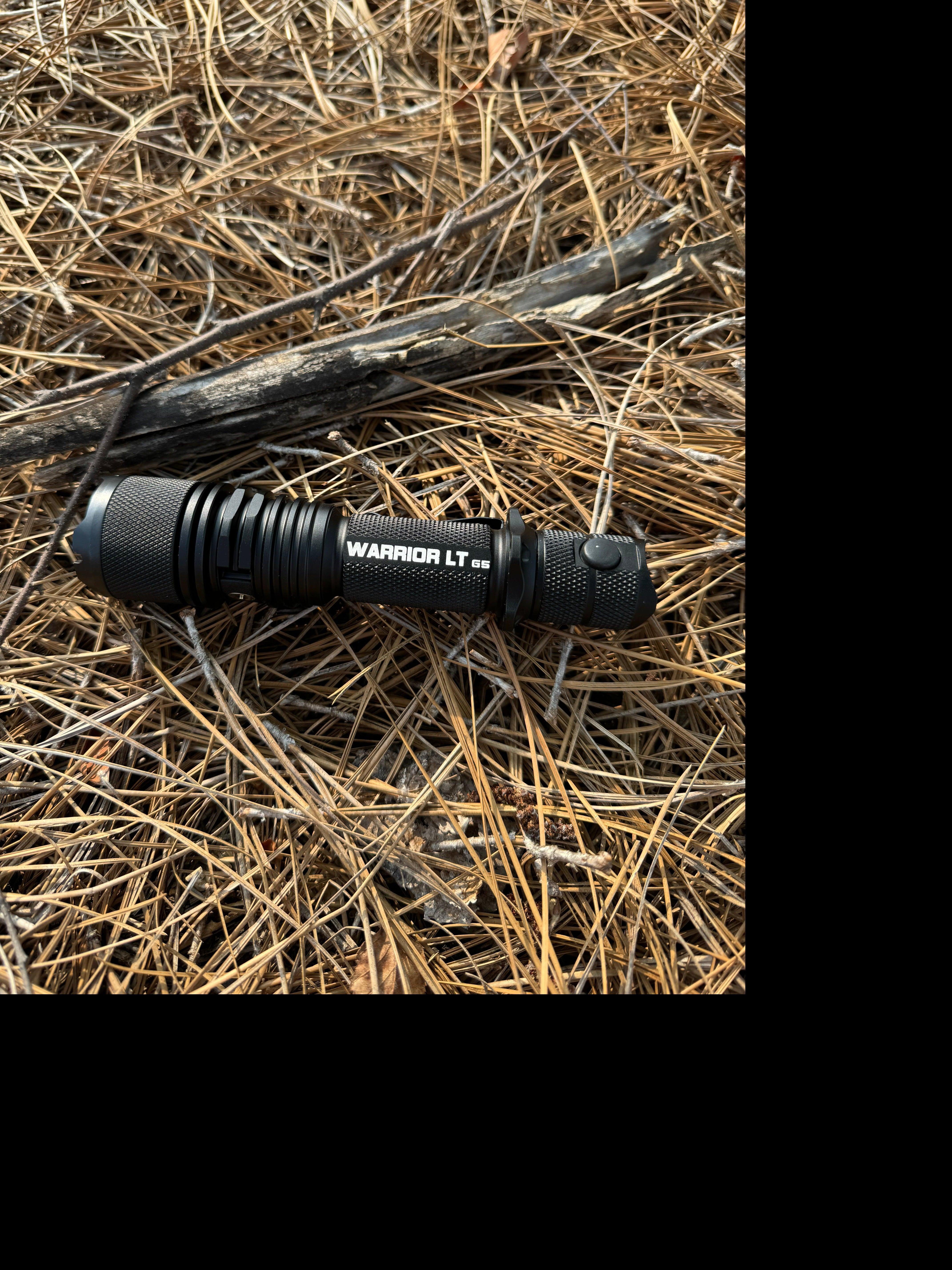 Black aluminum tactical flashlight by Powertac, featuring long throw and 3050 lumens brightness.