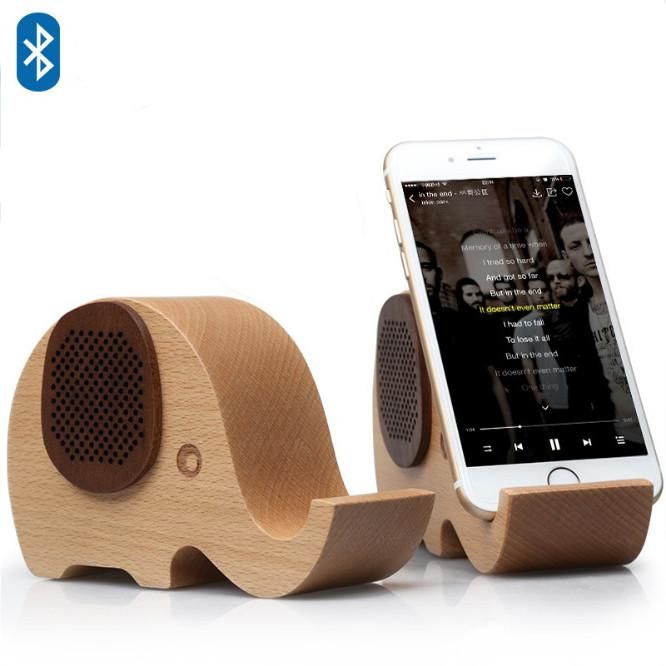 Wooden elephant-shaped Bluetooth speaker phone stand by Doba, features natural wood finish and speaker grille.